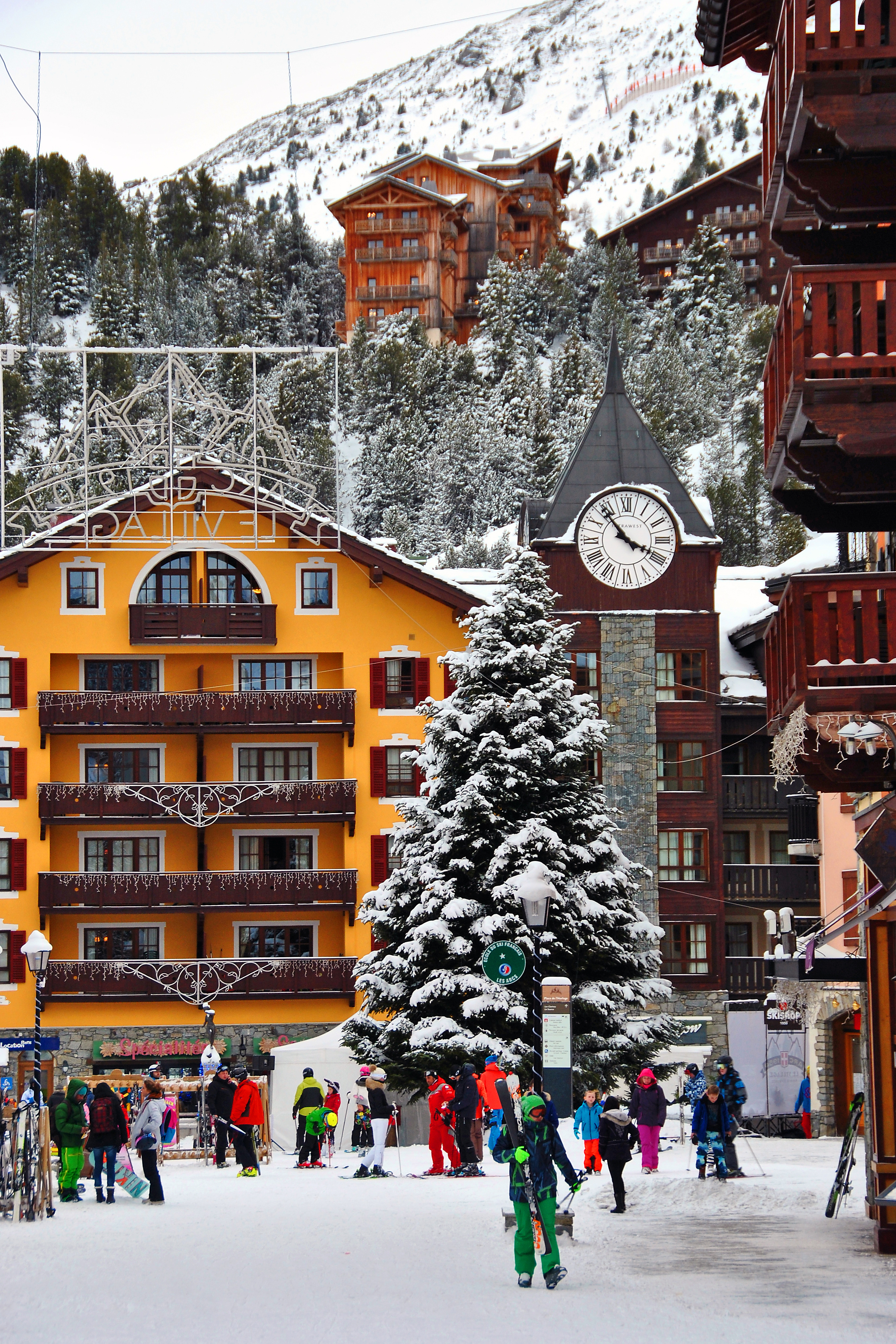 Skiers and visitors in the snowy pedestrian village centre of Arc 1950 in Les Arcs